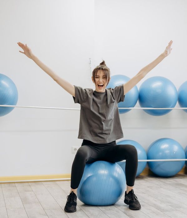 Woman feeling energetic and balanced in a bright living room.